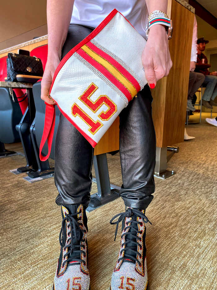 Randi Mahomes, mother of Patrick Mahomes, wears a bedazzled purse and shoes adorned with her son's jersey number.